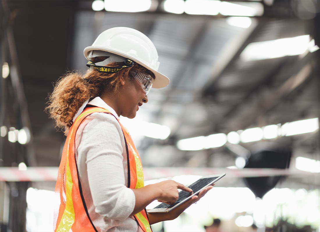 Blog - Female Engineer Looking at a Tablet in an Industrial Plant