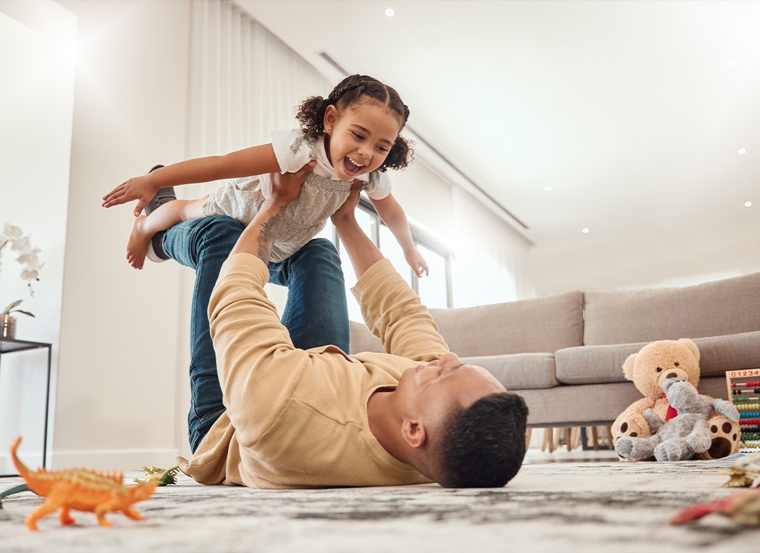Personal Insurance - Father and Daughter Playing at Home While Bonding and Enjoying Quality Time Together